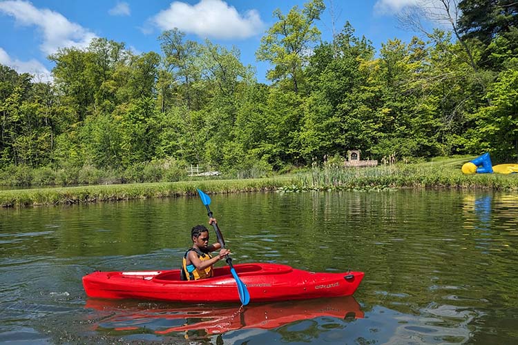 A Garfield School sixth grader plies the water at Camp Ho Mita Koda